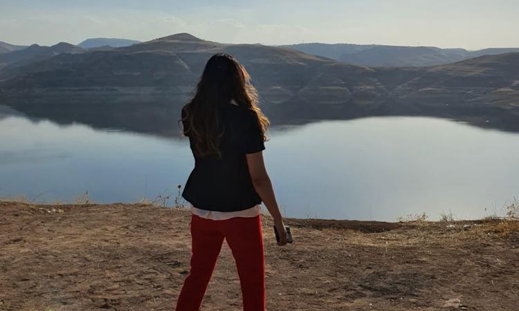 rs34_mhf-33-view-of-nature A woman stands outside in front of a lake