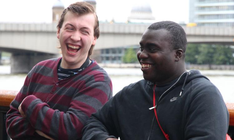 learning-disabilities-body-1 Two men sat outside laughing together