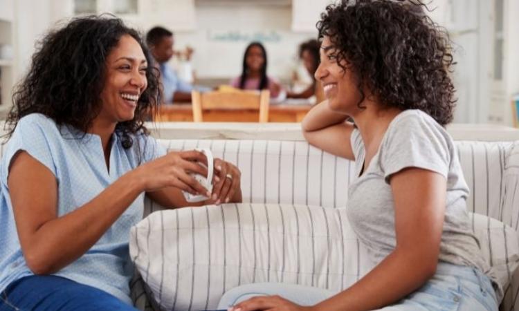 two-women-talking-1 Two women sat on a sofa talking together